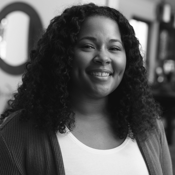 A woman with curly hair smiling