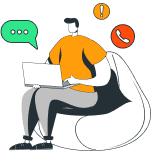 A man sitting on a bean bag with a laptop