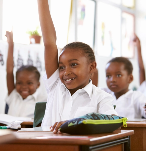 A group of children raising their hands